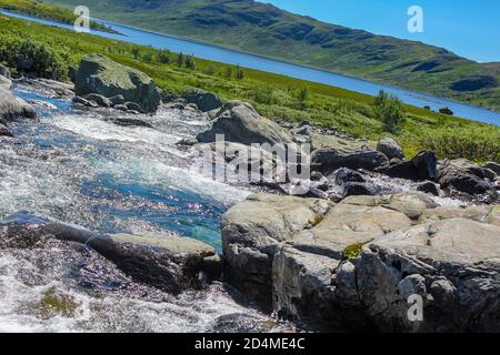 Beautiful Storebottåne river flows into the vavatn lake. Summer landscape in Hemsedal, Norway. Stock Photo