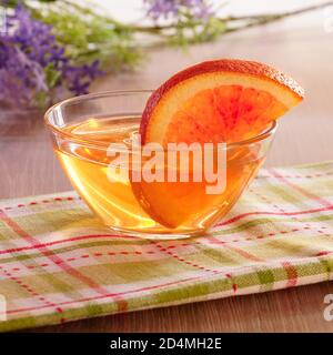 Orange jelly and orange slices in glass cup. Stock Photo