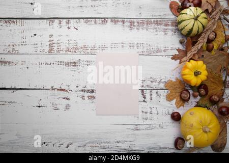 blank card on wooden table next to autumn composition Stock Photo