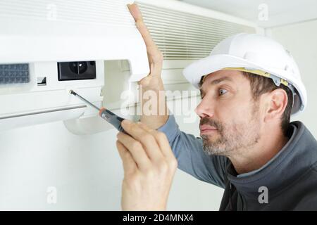 worker installing an air clim Stock Photo