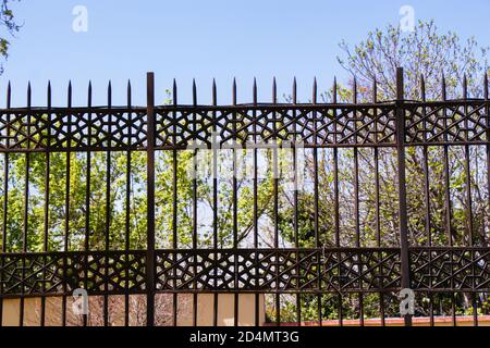 Decorative metal fence in a park Stock Photo