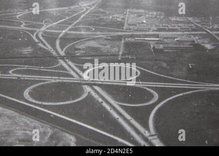 Fine 1970s vintage black and white aerial photography of a cloverleaf highway interchange. Stock Photo