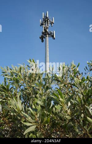 Mobile phone tower against blue sky Stock Photo