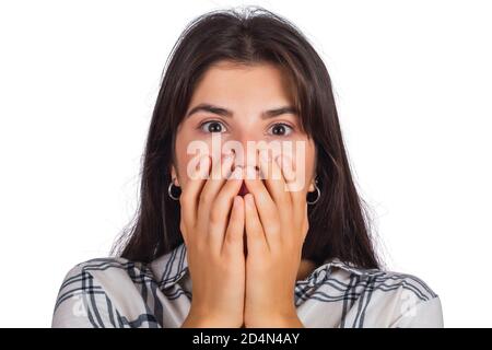 Portrait of young beautiful woman with shocked expression isolated against white background. Stock Photo