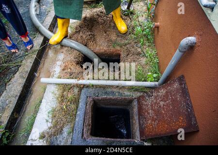 Emptying household septic tank. Cleaning and unblocking clogged drain. Stock Photo