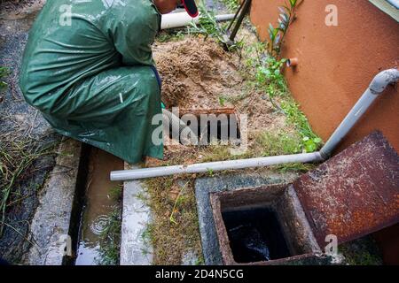 Emptying household septic tank. Cleaning and unblocking clogged drain. Stock Photo