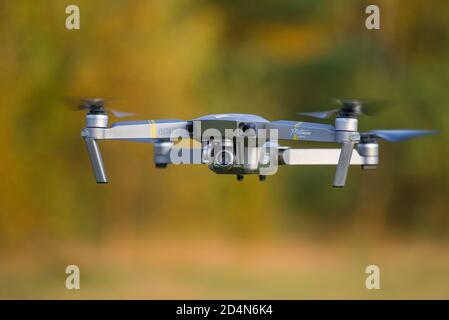 SUORANDA, RUSSIA - SEPTEMBER 26, 2020: Flying quadrocopter Mavic Pro 1 close-up on a yellow-green blurred background Stock Photo