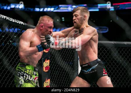 Boston, Massachusetts, USA. 18th Jan, 2015. Featherweight professional mixed martial artist and boxer from Dublin, Ireland CONOR ''NOTORIOUS'' MCGREGOR, 26, (black trunks) and bloody Russian DENNIS SIVER, 36 (green shorts) in their main event fight at UFC Fight Night 59 Boston at the TD Garden on Sunday. Credit: Kelvin Ma/ZUMA Wire/Alamy Live News Stock Photo