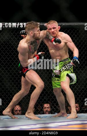 Boston, Massachusetts, USA. 18th Jan, 2015. Featherweight professional mixed martial artist and boxer from Dublin, Ireland CONOR ''NOTORIOUS'' MCGREGOR, 26, (black trunks) dominating an already very bloodied Russian DENNIS SIVER, 36, (green shorts), in their main event fight at UFC Fight Night 59 Boston at the TD Garden on Sunday. Credit: Kelvin Ma/ZUMA Wire/Alamy Live News Stock Photo