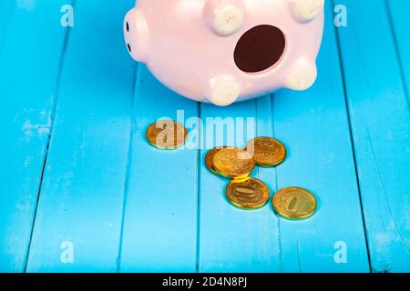 Pig piggy bank on a blue wooden background. Stock Photo