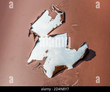 Falling off paint or paint exfoliating from a metal surface. Stock Photo