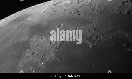 London, UK. 10 October 2020. Detailed images of the Moon are captured in very clear sky with no light pollution before dawn, and before clouds roll in after sunrise. Image: The crescent shape of the Montes Jura mountain range above the flat floor of Sinus Iridum. Credit: Malcolm Park/Alamy Live News. Stock Photo