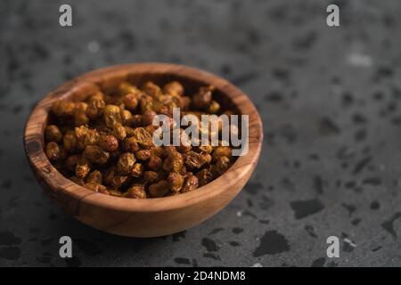 dried seaberry buckthorn in olive bowl on terrazzo countertop with copy space, shallow focus Stock Photo