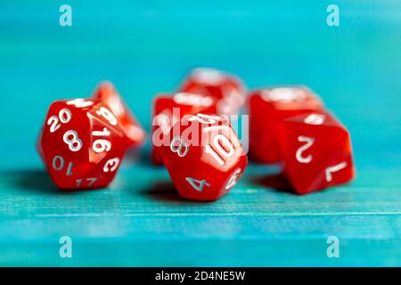 Simple red board dice set. Multiple role playing game polyhedral dice laying on the table, blue background. Tabletop games accessories Stock Photo - Alamy
