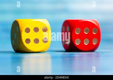 Two colorful wooden game dice showing number six, luck in board games, good chances, great odds abstract concept. Lucky roll numbers, winning concept Stock Photo