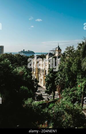 Close up aerial view of beautiful Malaga City Hall in Spain. Famous viewpoint and touristic landmark that looks like a castle. Sunny day, blue sky Stock Photo