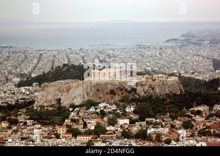 View of Athens, the Acropolis of Athens and the Parthenon from Mt. Lycabettus. Piraeus port and Faliron in the background Stock Photo