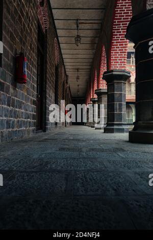 old brick wall passage in a Puneri Wada Stock Photo