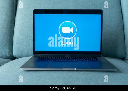 Laptop showing Zoom Cloud Meetings app logo. Work and have meetings from home. Stock Photo