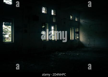 old abandoned building with light coming from the windows Stock Photo