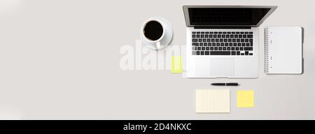 Workspace with laptop, office supplies. Stylish table desk, image with copy space on gray background Stock Photo