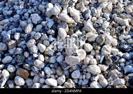 Natural chalk stones background. Chalk is a soft, white, porous, sedimentary carbonate rock, a form of limestone composed of the mineral calcite. Rock Stock Photo