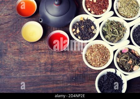assortment of dry tea on wooden background Stock Photo