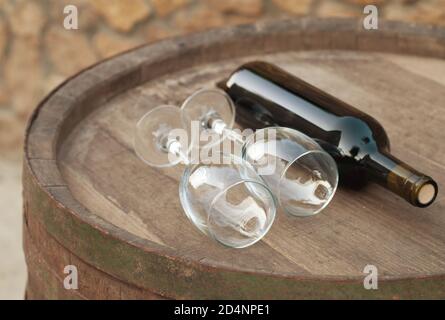 bottle over wine barrel Stock Photo