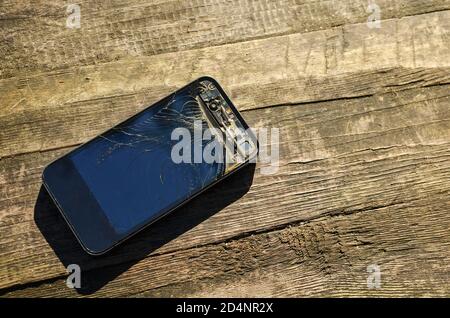 Mobile smartphone with broken screen isolated on white background with. Repair gadgets Stock Photo