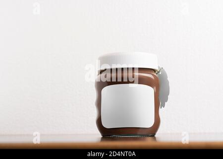 Hazelnut spread chocolate jar with round cap on black table, editable mock-up series template ready for your design, selection path included. Stock Photo