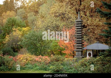 Stone 13-tier pagoda and tea house in the Main Botanical garden of the Academy of Sciences of Russia (exhibition ' Japanese garden) Stock Photo