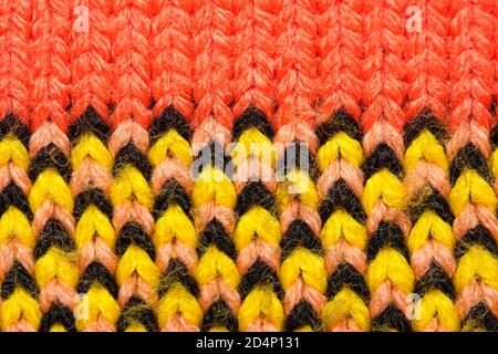 Colorful synthetic knitted fabric close up. Patterned knitted fabric texture background Stock Photo