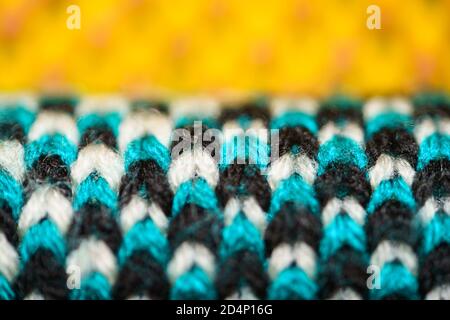 Colorful synthetic knitted fabric close up. Patterned knitted fabric texture background Stock Photo