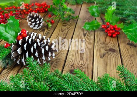 Green Christmas and winter decoration against wooden background Stock Photo