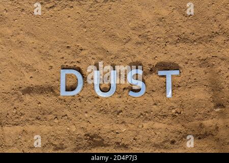 the word dust on dusty road surface in flat lay perspective Stock Photo