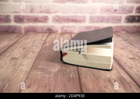 close up of a diary and a pencil on wooden table  Stock Photo