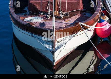 Small sailing boat moored in the yacht club of Portonovo on a clear Summer day, Pontevedra, Spain. Stock Photo
