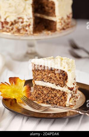 Slice of US southern hummingbird cake with a pineapple flower on the side Stock Photo