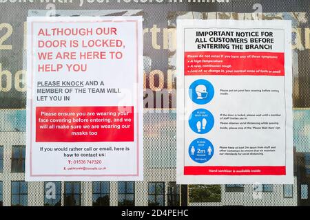 Security notice in the window of an estate agent's shop at a shopping centre, Corby, Northants, England, during the coronavirus crisis, October 2020. Stock Photo