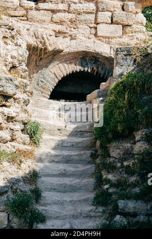 Vertical shot of old stone stairs on a historic tunnel Stock Photo