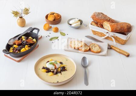 Thick creamy soup with fresh forest mushrooms, poached eggs and potatoes. Favorite season mushroom lunch or dinner in Czech Republic. Stock Photo