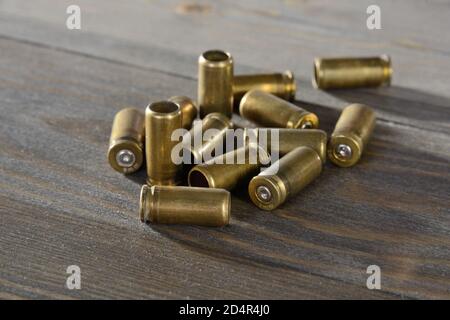 spent cartridges on an old wooden table Stock Photo