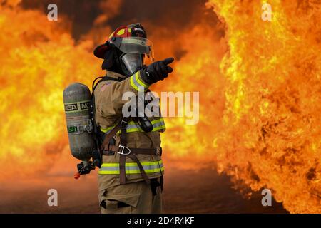 Tech. Sgt. Jordan Salas, a fire training NCO in charge, assigned to the 36th Civil Engineer Squadron, Andersen Air Force Base, Guam conducts a live fire training burn, January 8, 2020, at AAFB. The joint-training allowed 28 firefighters from Yap, Palau, Chuuk, Saipan, Rota, Guam Airport and the 36th CES to share mutual operational knowledge and experience when responding to a downed aircraft. Stock Photo