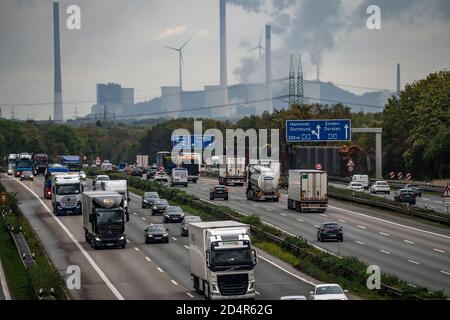 Heavy traffic with many trucks on the freeway A2, at the freeway junction Bottrop, view to the east, behind the Uniper power plant in Gelsenkrichen-Sc Stock Photo