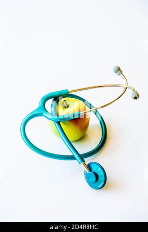 Conceptual image about the benefits of a balanced diet on health, " An apple a day keeps the doctor away " . Stock Photo