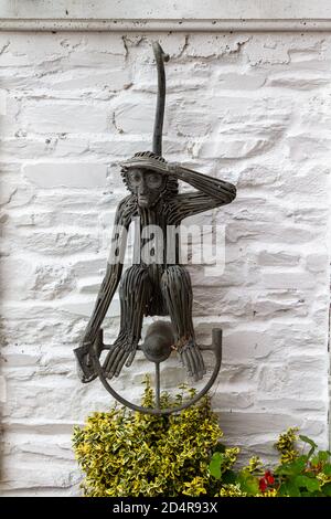 Monkey sculpture hanging on wall Stock Photo