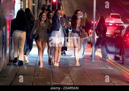 People out socialising in Newcastle city centre, ahead of the 10pm curfew that pubs and restaurants are subject to in order to combat the rise in coronavirus cases in England. Cities in northern England and other areas suffering a surge in Covid-19 cases may have pubs and restaurants temporarily closed to combat the spread of the virus. Stock Photo