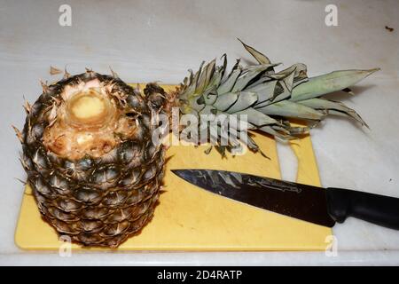 Pineapple and Knife on cutting board Stock Photo