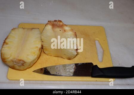 Cut Pineapple and Chef Knife Stock Photo