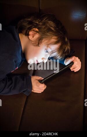 4 year old boy playing with a smartphone. Stock Photo